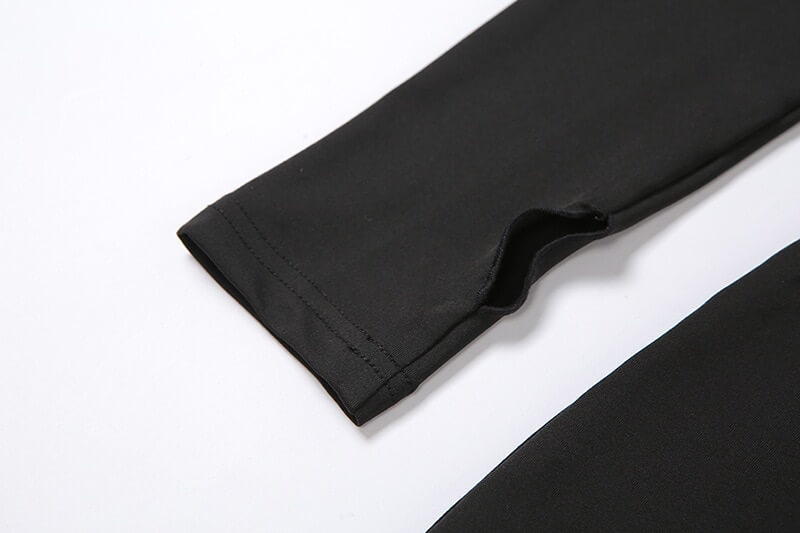 Close-up of black sports asymmetrical elastic high-waist romper sleeve detail, showing stretchy fabric and solid pattern.